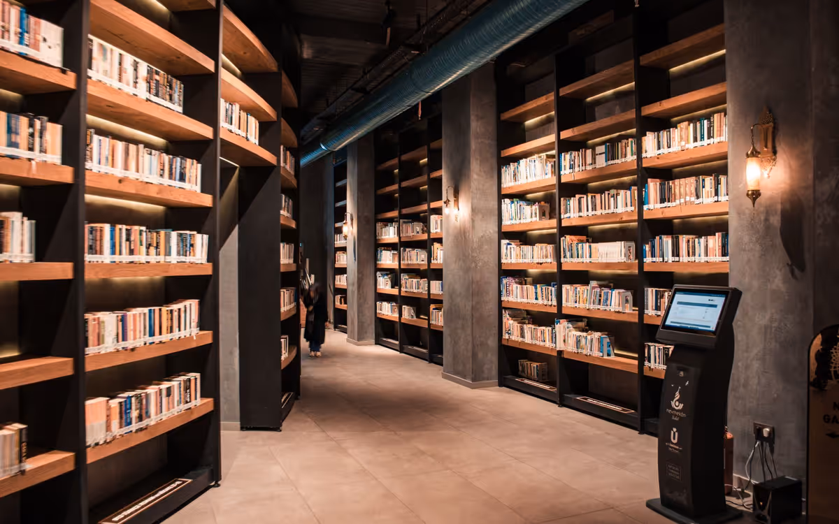 Library stacks with a single shelf lit, suggesting readable passages for retrieval.