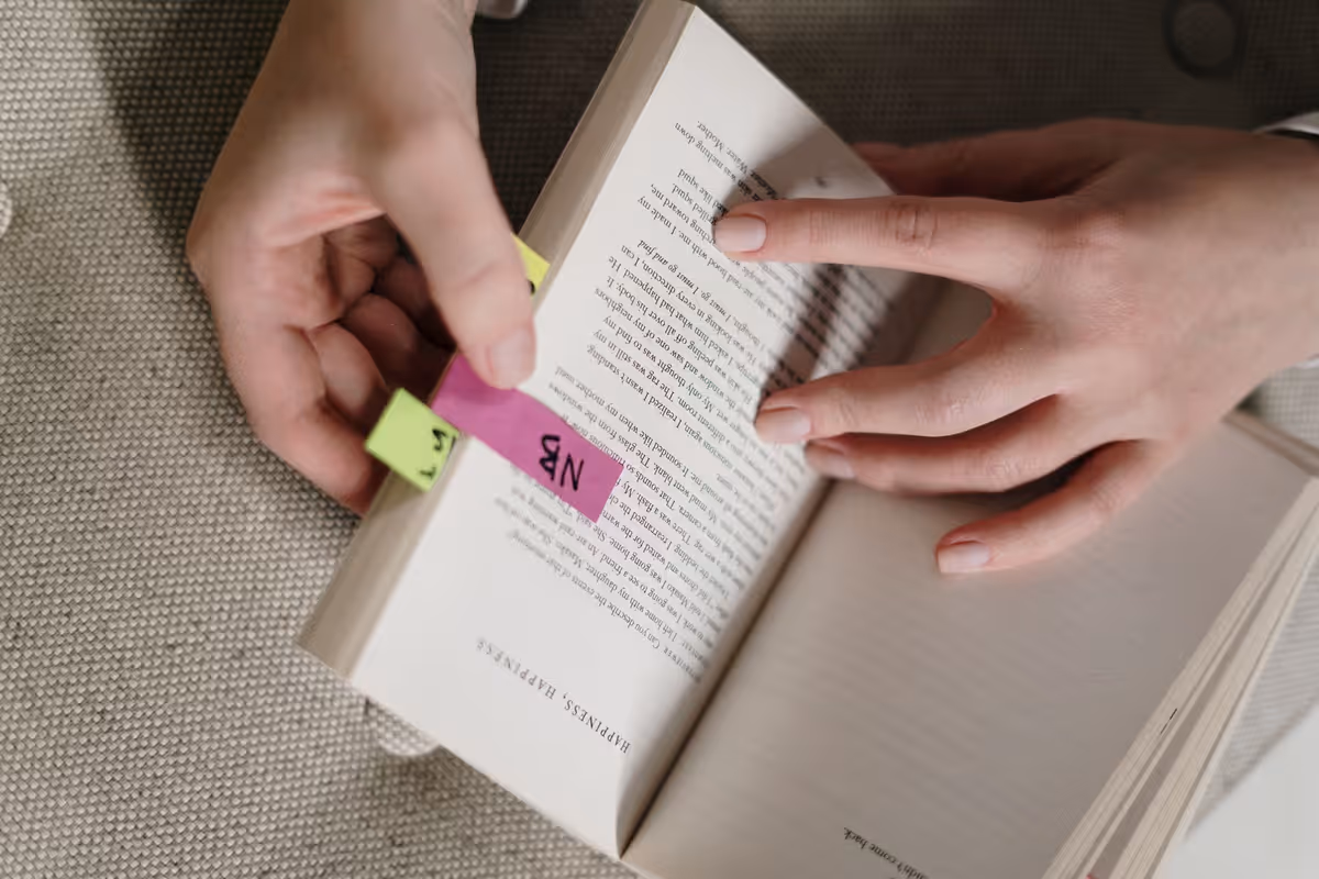 Open book with sticky notes suggesting citable passages.